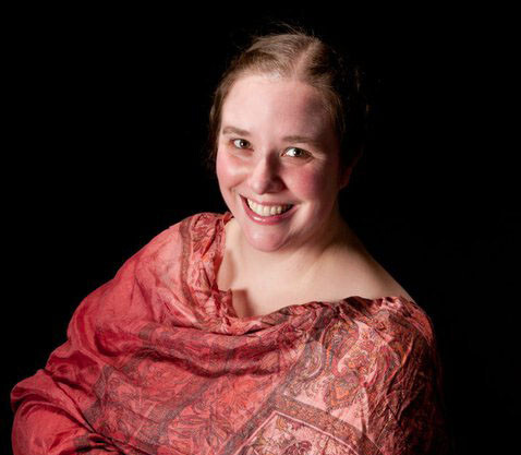 Kristin Kinman in front of a black background