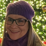Janice Ledgerwood in front of a tree covered in lights