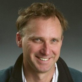 Steven Neshyba in front of a gray background