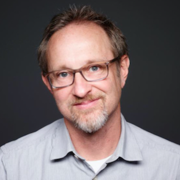 Craig Welch in front of a black background