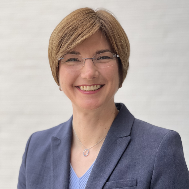 Erika Shugart in front of a white wall