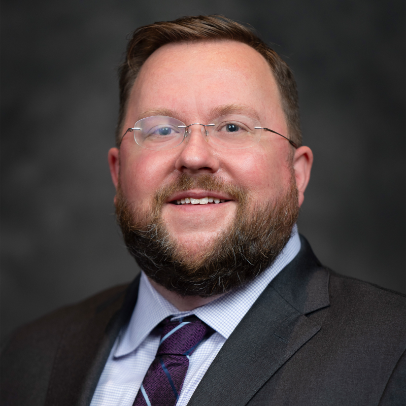 Christofer Nelson in front of a black background