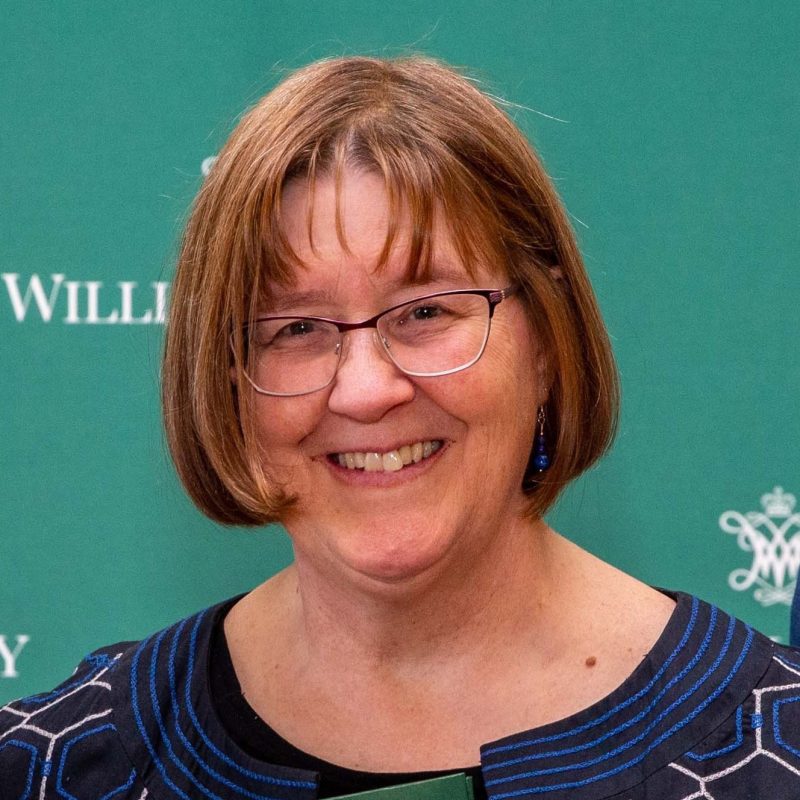 Heather Macdonald in front of a green background.