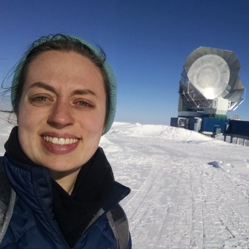 Amy in the snow in front of research equipment
