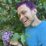 Keegan holding purple flowers