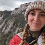 Kiley in front of a cliffside