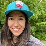 Lynn in front of green foliage