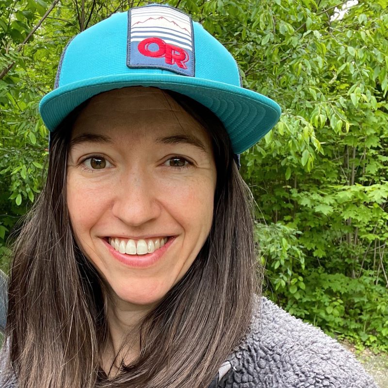 Lynn in front of green foliage
