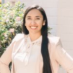Monica in front of a white brick wall