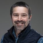 Seth in front of a gray background