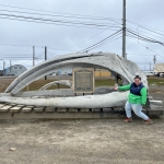 Jeanette poses in front of a whale skull