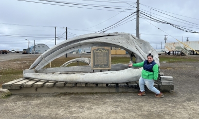 Jeanette poses in front of a whale skull