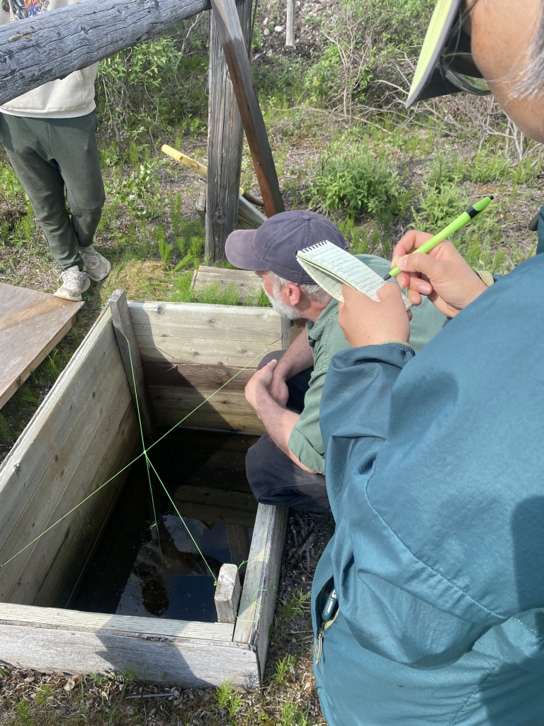 Yoko notes observations and data points as the ice cellar is opened.