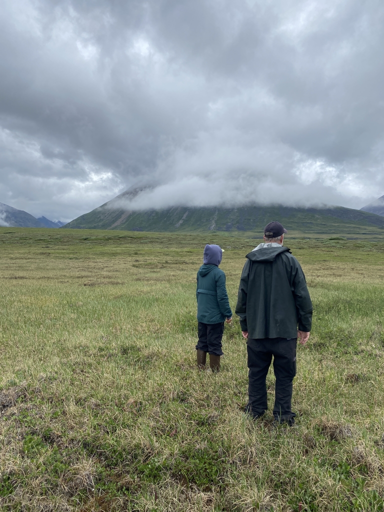 Mike and Yoko geotagging potential locations for a new ice cellar, based on discussions with village leaders and elders.