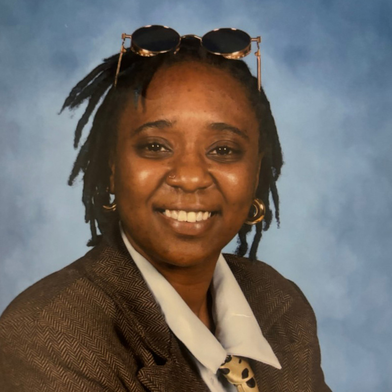 Patricia in front of a blue background
