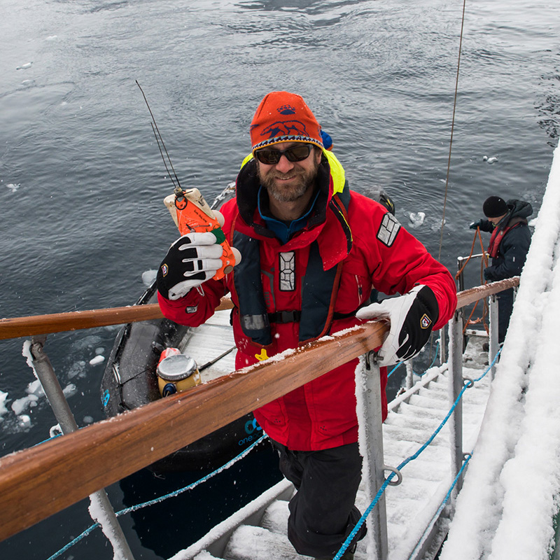 Ari poses on the stairs of a ship