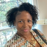 Tiffini in front of a window with trees in the background