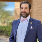 Zachary in front of a brick building