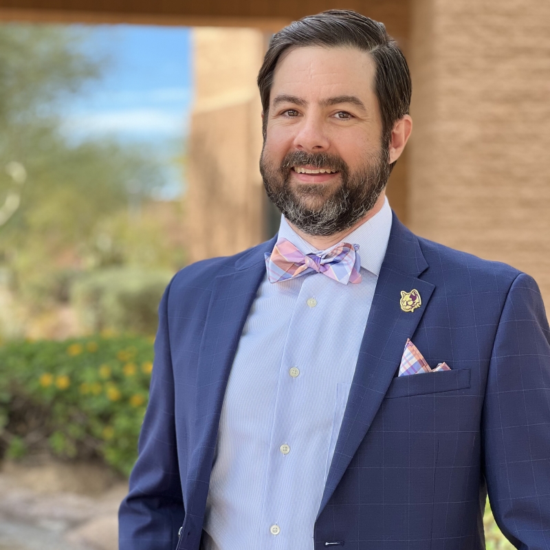 Zachary in front of a brick building