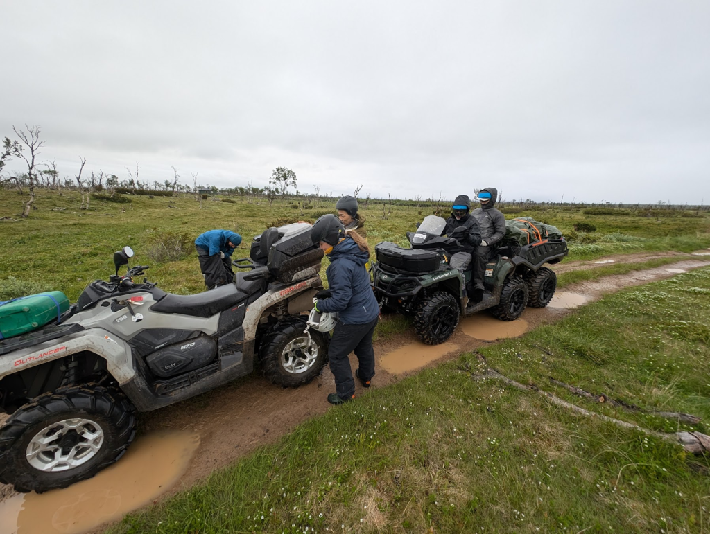 The team of five loads up equipment on ATVs