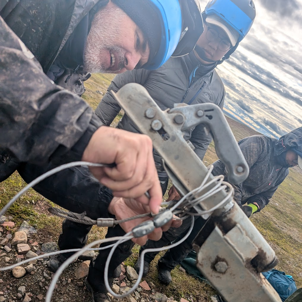 Members of the team working on a piece of equipment