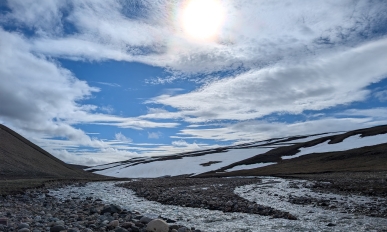 View of the Narssarssak River watershed includes snow, exposed rock and running water