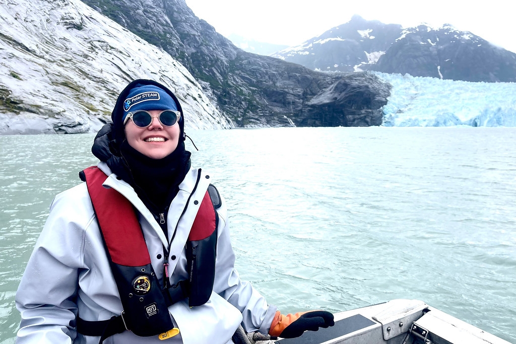 A woman smiling with a glacier in the background