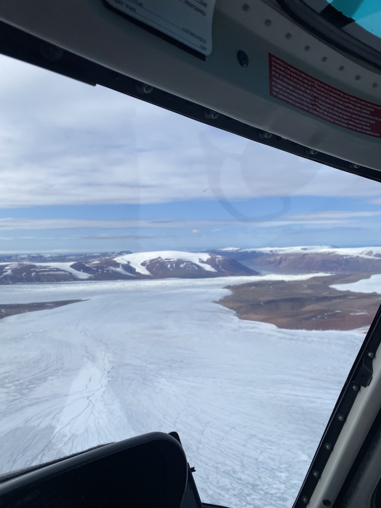 View out of a window from above of mountains and snow