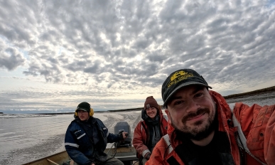 Three people smiling in a boat