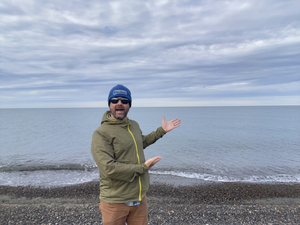 Zachary stands in front of water