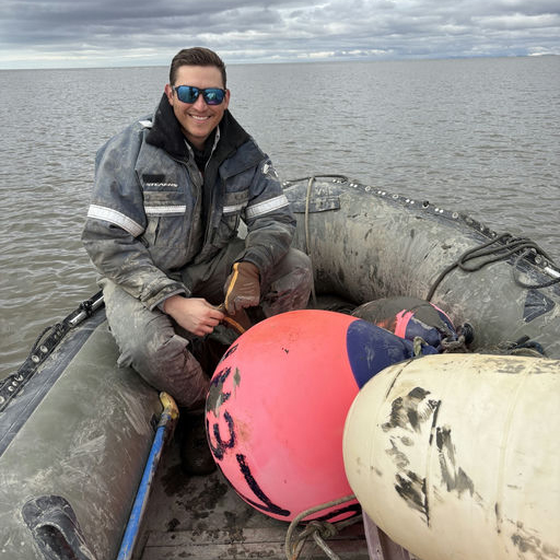 James sitting on a boat