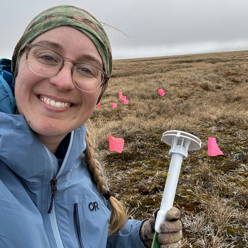 Katie with research equipment in a field