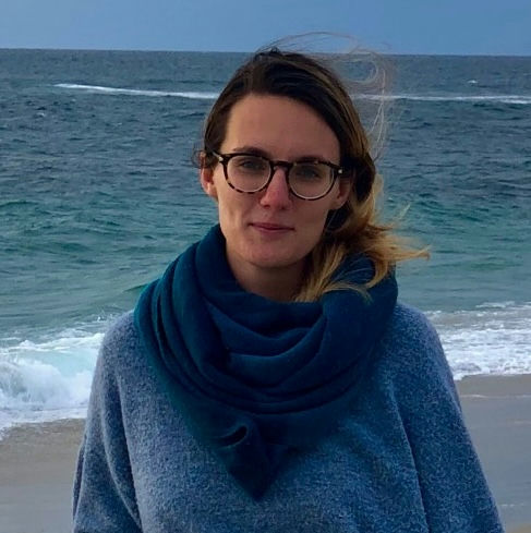 Margaret standing in front of the ocean