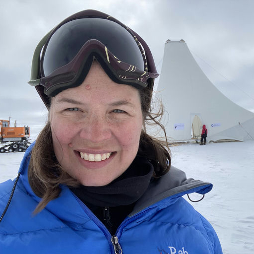 Steph wearing goggles in front of a snowy background