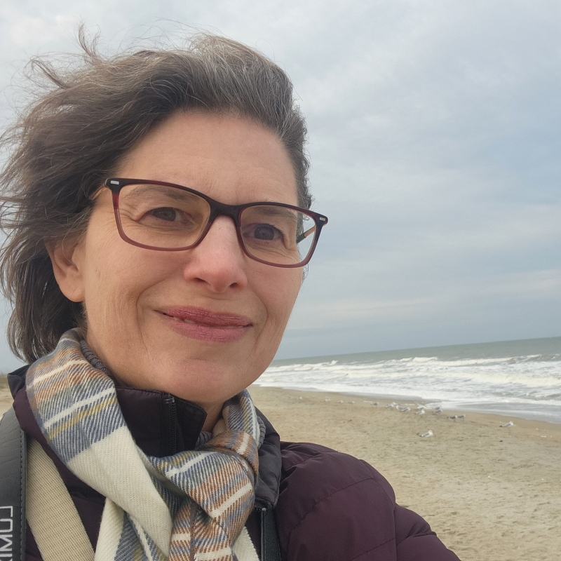 Kathy smiling on a beach