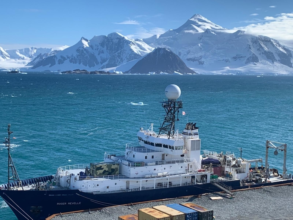 View from above of a ship with mountains in the background
