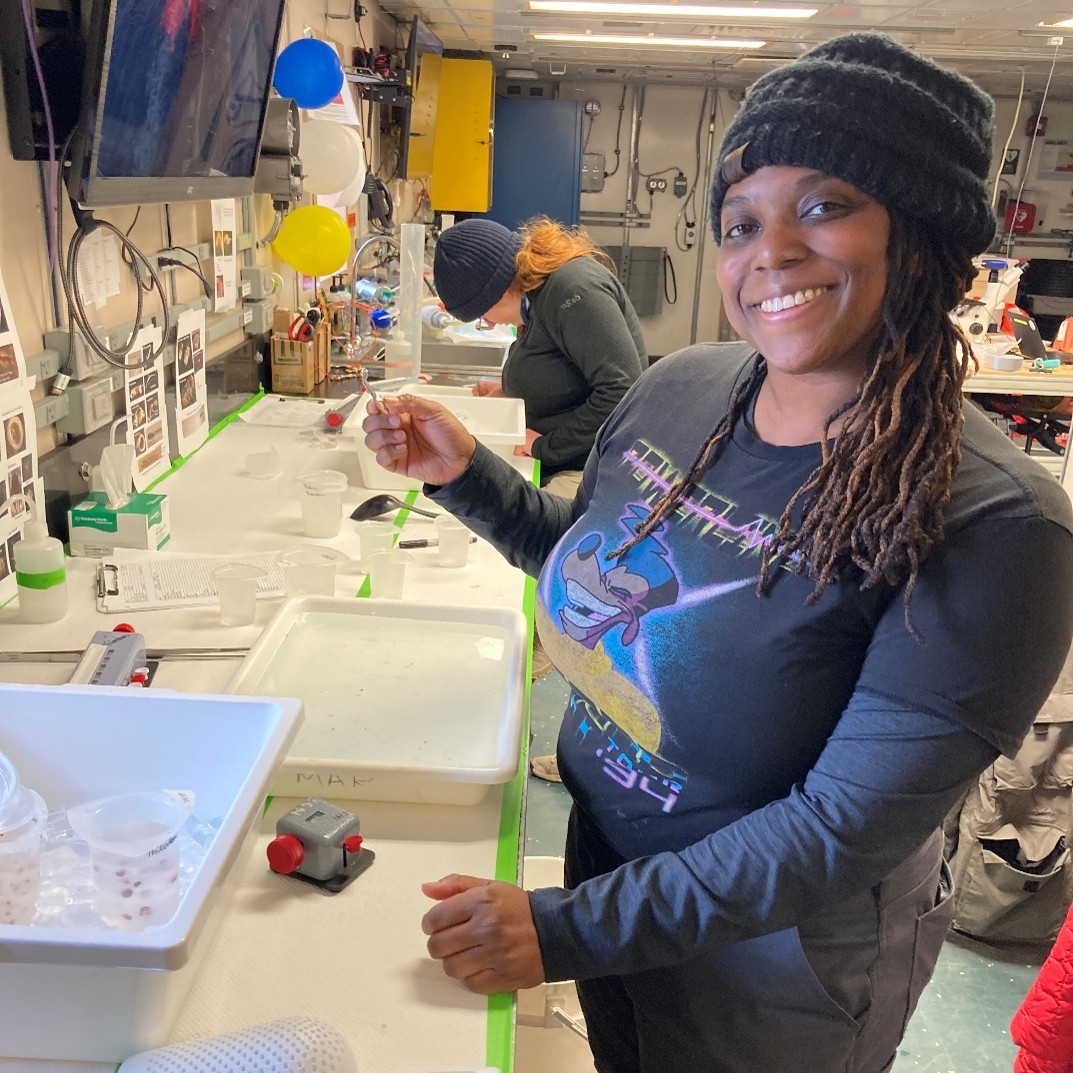 Woman artist assisting in zooplankton processing in the lab.