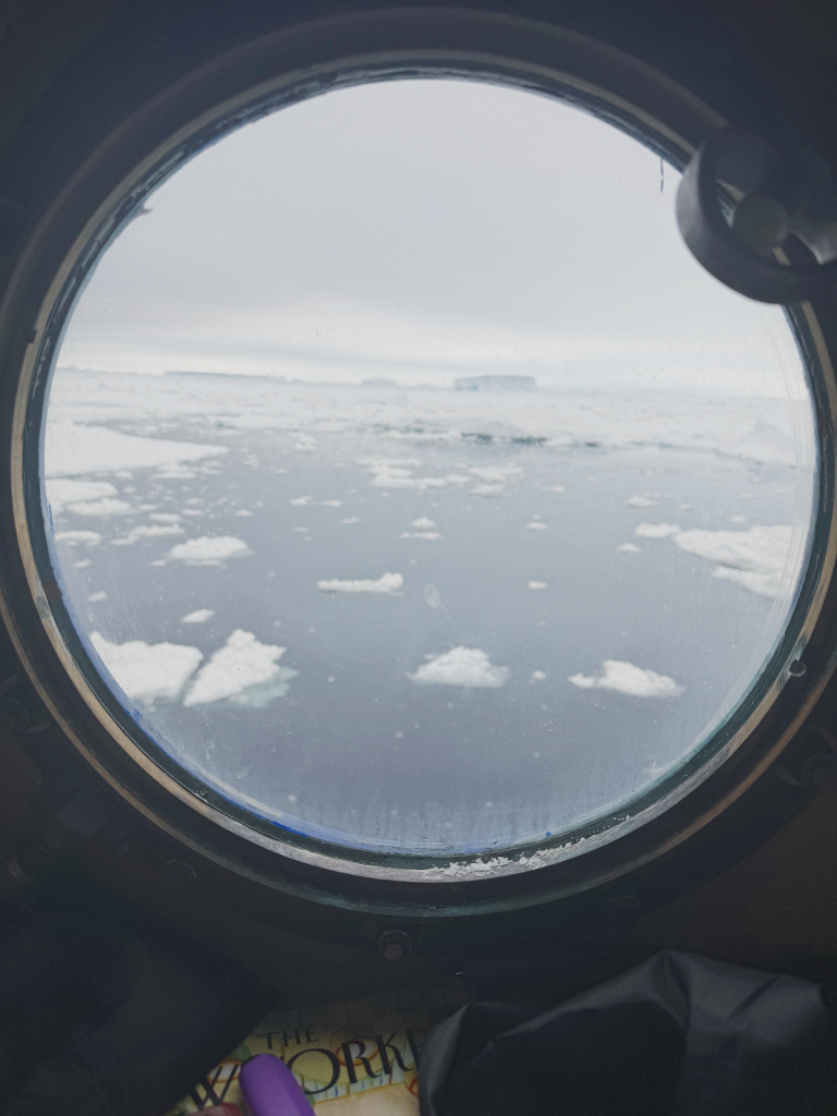 View from window showing ice breaking up and water