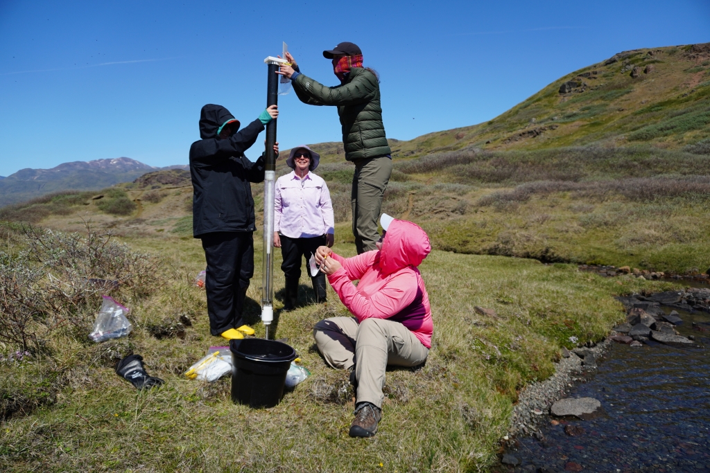 Research team members Avery Lamb, Jasmine Saros, Margaret O'Brien, and Heather Vingsness (me) sectioning a sediment core into bags for testing
