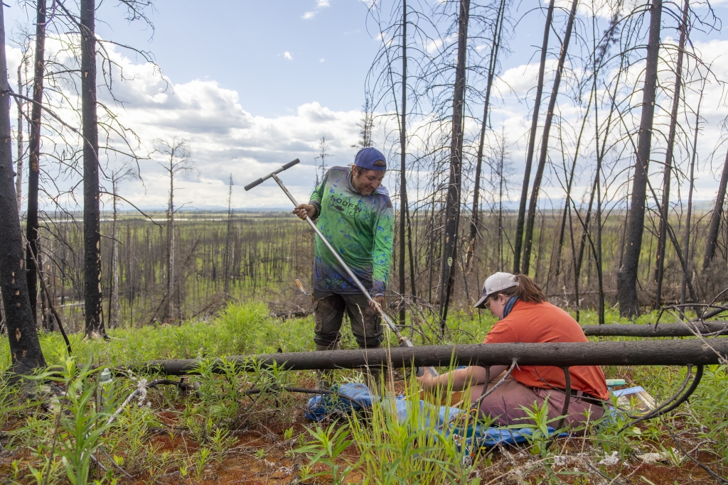 Two people using equipment to collect samples