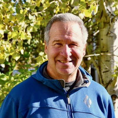 Jay smiling in front of a tree