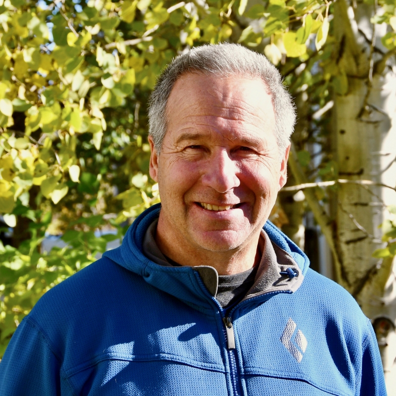 Jay smiling in front of a tree