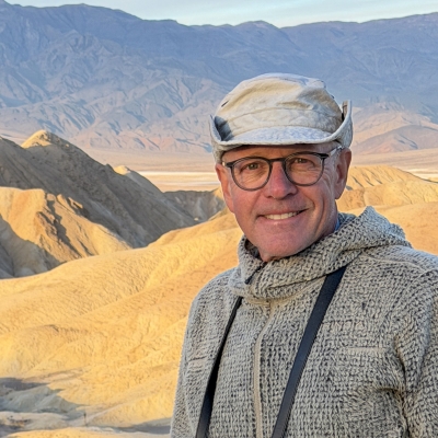 Brad in front of a background of mountains