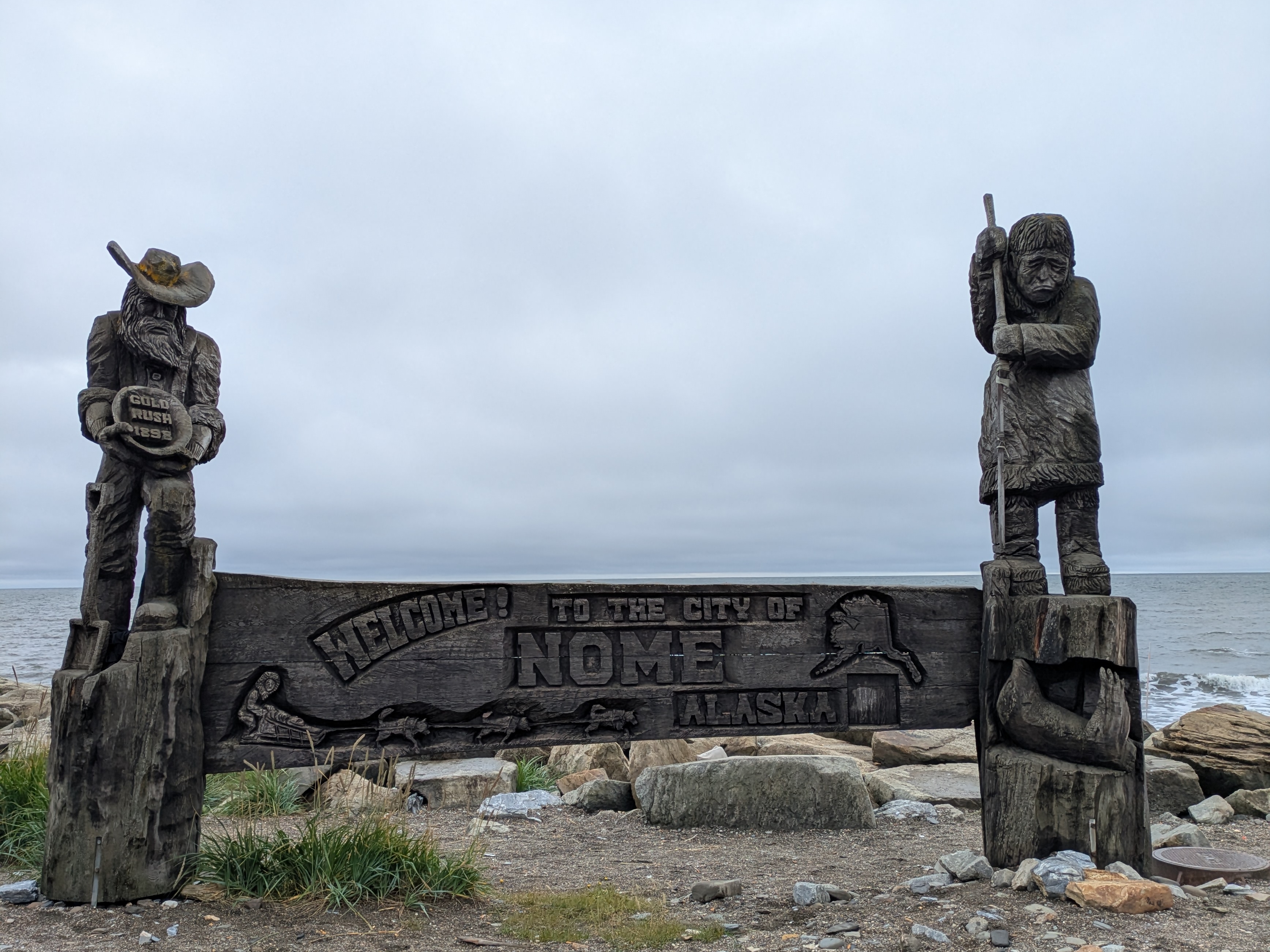 Welcome to Nome sign featuring a gold miner and a native Alaskan